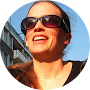 A profile picture of a smiling woman wearing black sunglasses who left a review for Andrew Thomas Contractors