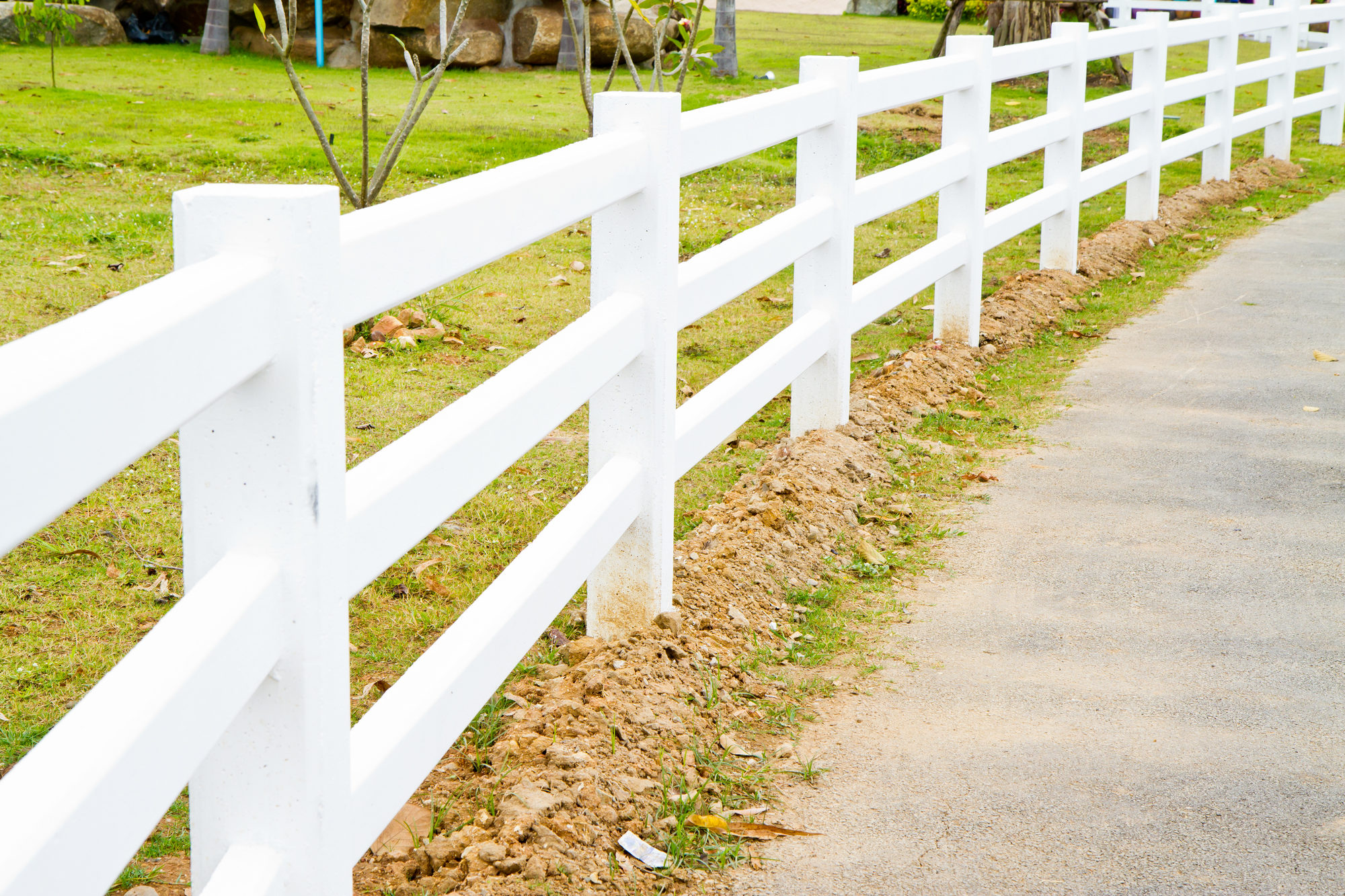 White vinyl fence surrounding a ranch