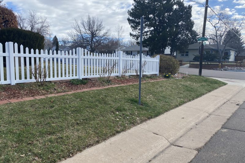 White vinyl picket fence in Denver residential area