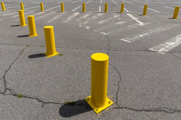 Empty Parking Lot with Yellow Bollards